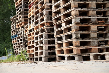 wooden pallets stacked high on top of each other in a companys factory yard in london no people stock photo