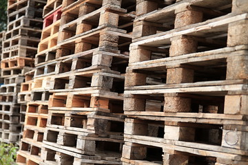 wooden pallets stacked high on top of each other in a companys factory yard in london no people stock photo