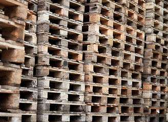 wooden pallets stacked high on top of each other in a companys factory yard in london no people stock photo