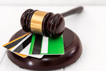 Judges gavel and credit card on table