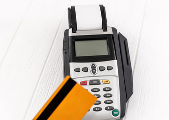 Credit card reader and credit card on table.