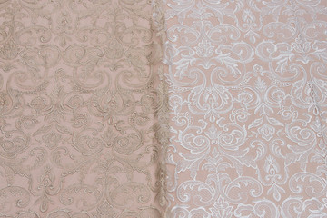 Texture lace fabric. lace on white background studio. thin fabric made of yarn or thread. a background image of ivory-colored lace cloth. White and beige lace on beige background.