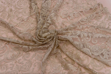 Texture lace fabric. lace on white background studio. thin fabric made of yarn or thread. a background image of ivory-colored lace cloth. Beige lace on beige background.
