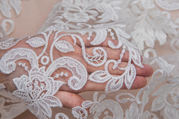 Texture lace fabric. lace on white background studio. thin fabric made of yarn or thread. a background image of ivory-colored lace cloth. White lace on beige background.