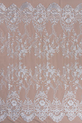 Texture lace fabric. lace on white background studio. thin fabric made of yarn or thread. a background image of ivory-colored lace cloth. White lace on beige background.