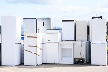 Fridge freezers outdoors at recycle depot for safe disposal refrigeration equipment and gas