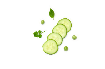 sliced cucumber peas seeds and parsley on white backgroun