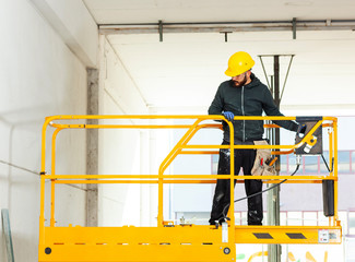 Worker builds a plasterboard wall.