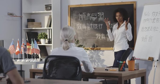 Teacher giving chinese lesson in a classroom