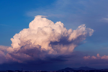 Big white cloud on a village, blue sky, outdoor