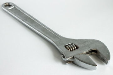 A large metal wrench on a white background