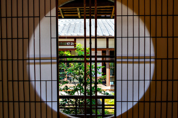 Round window with shoji at a traditional Japanese house in Nara, Japan