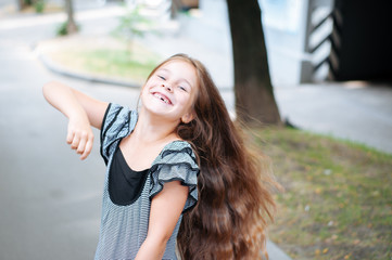 Little cute girl street city lifestyle shooting, summer, smiling at camera