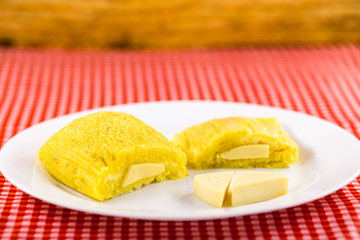 Pamonha, Brazilian sweet corn with cheese filling. Pamonha typical of Brazil, food of the state of minas gerais and goiais. Concept of traditional food. Brazilian food