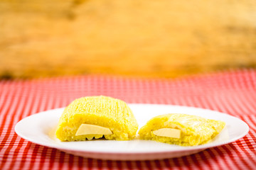 Pamonha, Brazilian sweet corn with cheese filling. Pamonha typical of Brazil, food of the state of minas gerais and goiais. Concept of traditional food. Brazilian food