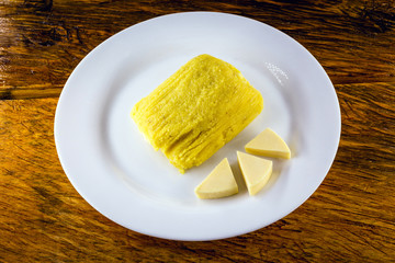 Pamonha, Brazilian sweet corn with cheese filling. Pamonha typical of Brazil, food of the state of minas gerais. Concept of traditional food. Brazilian food at rural parties in June and July.