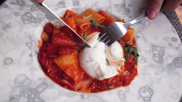 close up of italian pasta spaghetti with burrata cheese in a white plate