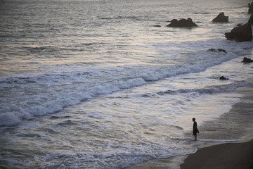 Contemplative Man Standing by Ocean