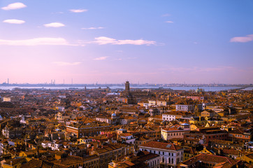 View of a red rooftop horizon, with blue skies over Venice.