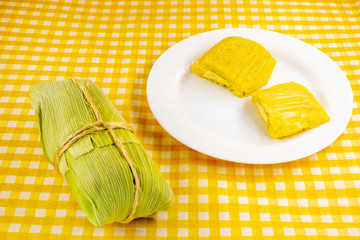 pamonha, Brazilian sweet made from homemade cheese with corn. Open pissing ready for consumption. Concept of traditional Brazilian sweet, typical food of the months of June and July.