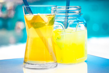 Fresh delicious green tea with apple and lemonade on the sea background.