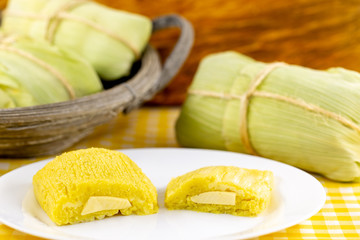 pamonha, Brazilian sweet made from homemade cheese with corn. Open pissing ready for consumption. Concept of traditional Brazilian sweet, typical food of the months of June and July.