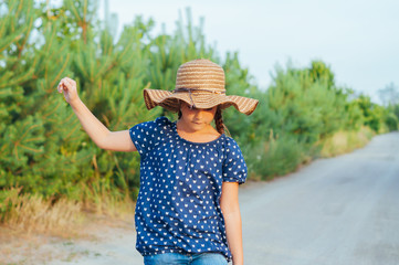 Portrait of a little cute girl in straw hat