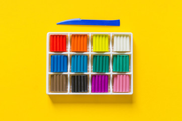 Obraz premium Stationery flat lay.Plasticine rainbow color stack and plastic board. Back to school.