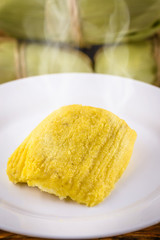 pamonha, Brazilian sweet made from homemade cheese with corn. Open pissing ready for consumption. Concept of traditional Brazilian sweet, typical food of the months of June and July.