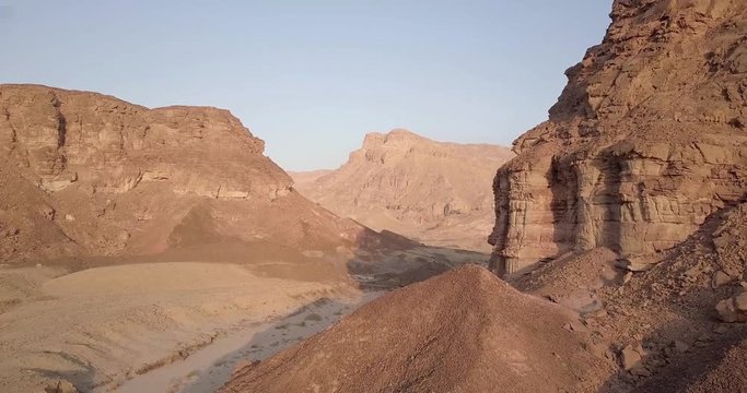 Flying over rocky desert mountains  Aerial view of Rocky Desert Mountains in Sasgon Timna Valley, Negev, Arava, Israel