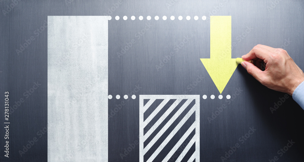 Poster costs cutting and efficiency concept. businessman drawing bar graph and arrow on chalkboard.