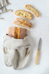 Homemade bread stored in a reusable linen bag with drawstring. Eco friendly Zero waste concept.
