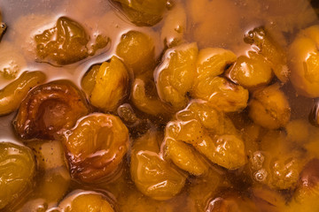 Background of apricots cooked in sugar syrup.