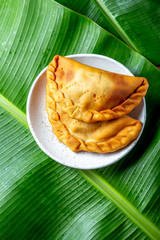 Easter Island Tuna empanadas on banana palm tree leaves. Top view