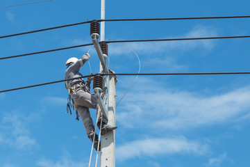 Electricians repairing,electricians repairing wire on electric power pole, power linesman climb the...