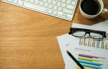 Workspace, top view with computer, eyeglasses, pencils, paper and coffee. During breaks.