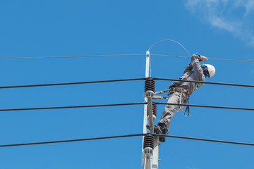 Electricians repairing,electricians repairing wire on electric power pole, power linesman climb the...