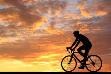 Fototapeta premium Silhouette Cycling on blurry sunrise sky background.