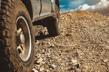 Fototapeta na wymiar 4x4 offroad car wheels in mountains
