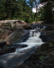 Fototapeta premium Waterfall over rocks background - vertical