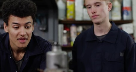 4K Young apprentice mechanic with bad attitude showing no interest to learn from his coworker