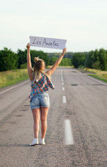 Beautiful Girl Hitchhiking On The Road Traveling.