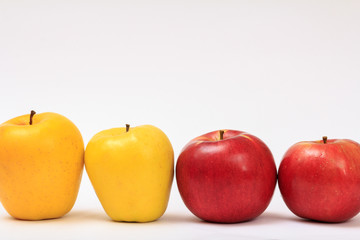 Row of ripe apples on a white background.