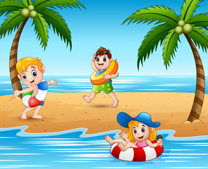 Obraz na płótnie Canvas Children with lifebuoy playing at the beach