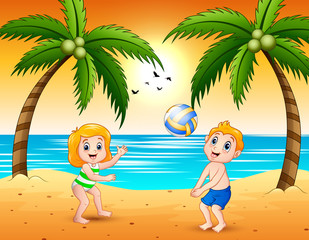 Obraz na płótnie Canvas Girl and a boy playing volleyball at the beach