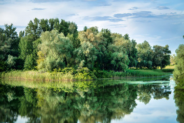 Fototapeta na wymiar beautiful summer water landscape after a thunderstorm - islands on the river