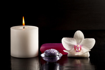 Candle, sea salt, soap and white orchid flower for spa.