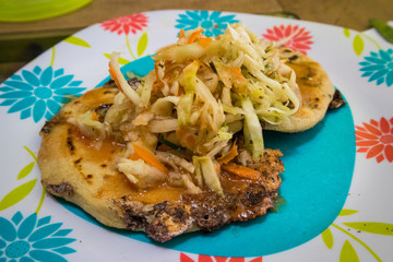 Papusas on a Plate Topped with Cabbage