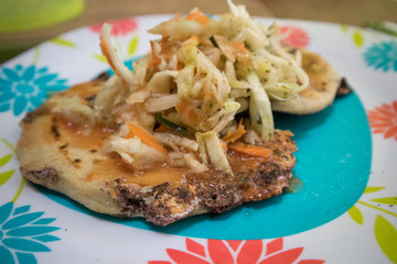 Papusas on a Plate Topped with Cabbage