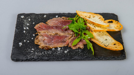 Beef Carpaccio With White Bread Croutons And Arugula